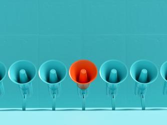 Red megaphone in line of blue megaphones